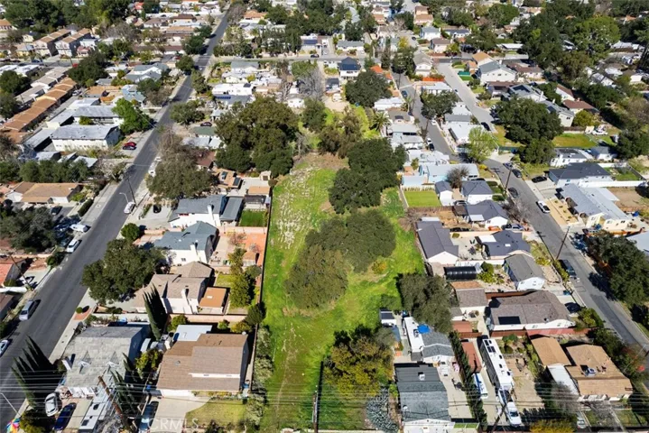 Extended aerial view of the front  and depth of the lot.
