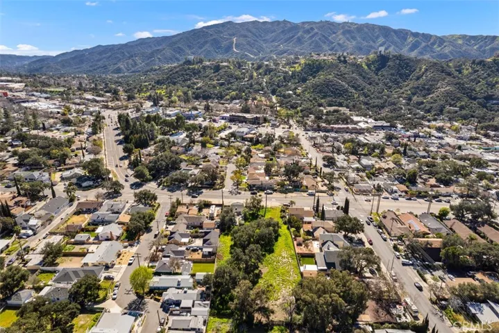Extended reverse side, aerial view of the lot showing Tujunga Canyon Blvd. crossing Sunland Blvd & front mountain view.