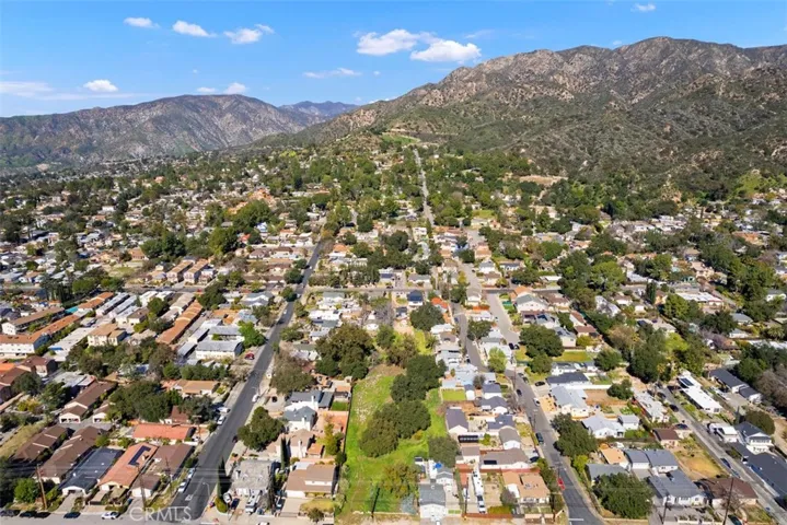 Extended aerial view showing local mountains.