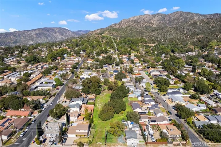 Extended aerial view showing local mountains.