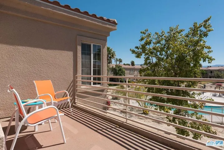 Rear patio has view of pool