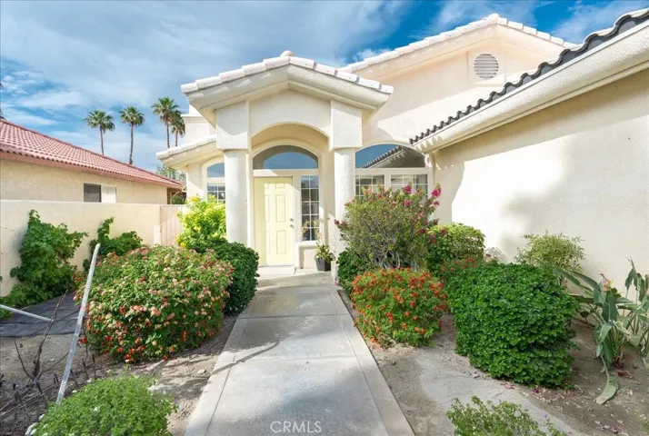 Entries are everything... here we have a gated front entry courtyard with flowering garden and grapevine growing on the wall.