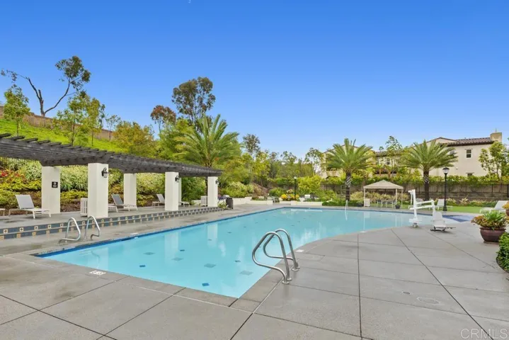 Large, heated Community Pool with beach entry, hot tub/spa, bathrooms, showers, and lots of seating!