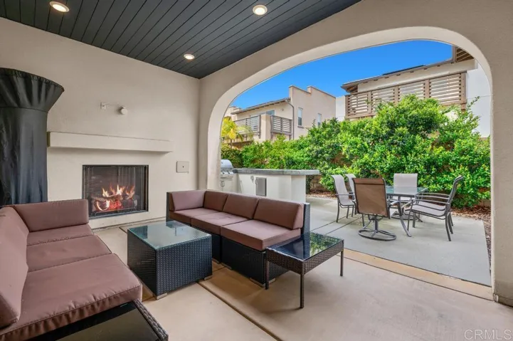 Covered Patio with Fireplace; open to backyard with Built-in BBQ with gas burner & lots of seating