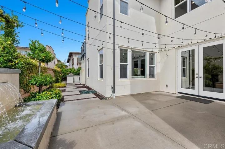 Side yard with water feature, lights and courtyard