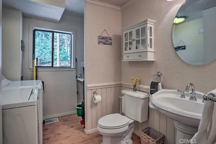 Main level half bath and laundry room combo.
