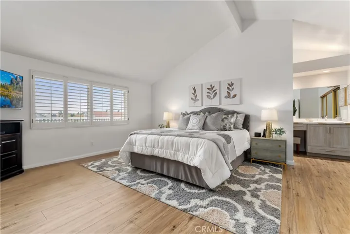 Primary suite features high ceiling and remodeled bathroom