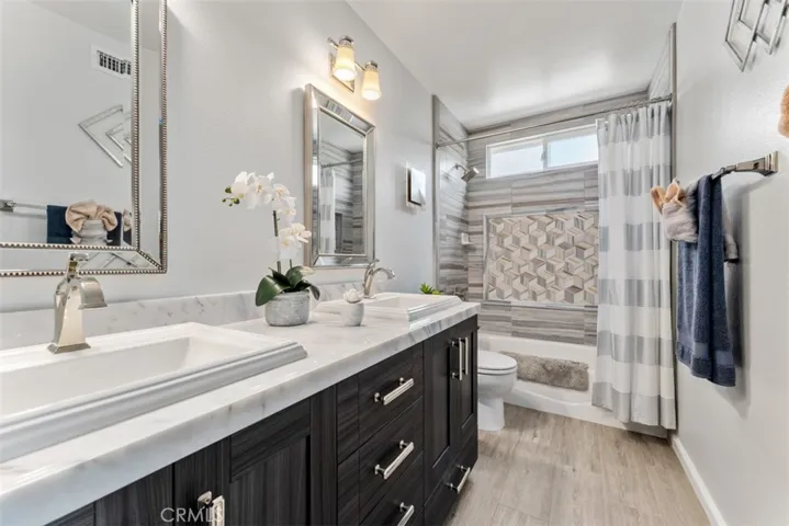 The secondary bathroom was also beautifully remodeled with comfort height dual-sink vanity and beautiful tile-work.