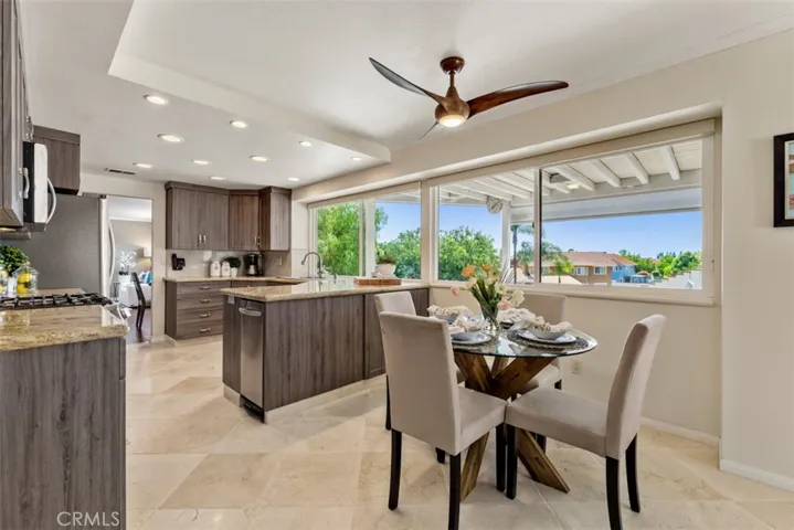 The remodeled kitchen overlooks the covered patio, pool, and expansive back yard.