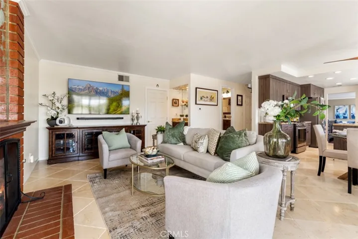 In this view of the family room you can see the breakfast area and kitchen to the right, the guest bathroom in the hallway leading to the front entry. In the center of the photo you can see the wetbar and the direct access to your three-car garage