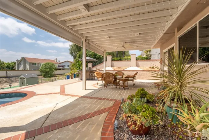 The patio has outdoor speakers, recessed lights, ceiling fan. [photo was taken prior to the new landscaping in the lower yard]