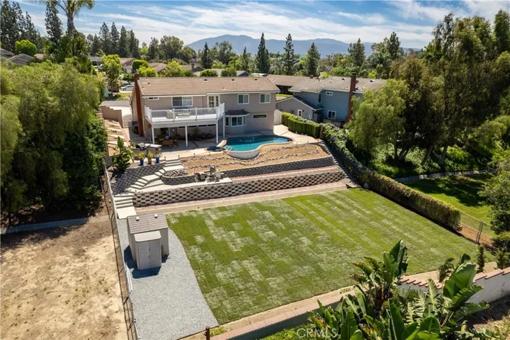 The lower yard is newly landscaped with new sod and Italian Cypress trees.