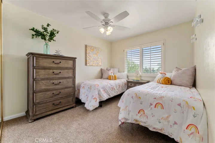 Bedroom 4 with newer carpet, dual paned low-e windows and plantation shutter