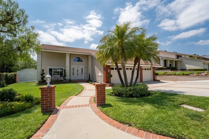 Welcome home! Such great curb appeal with a lush lawn and beatiful landscaping and long driveway leading to your 3-car garage.