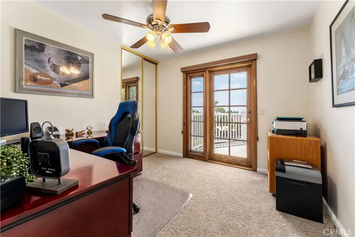 Bedroom 2 is currently used as an office. It opens to the spacious deck.