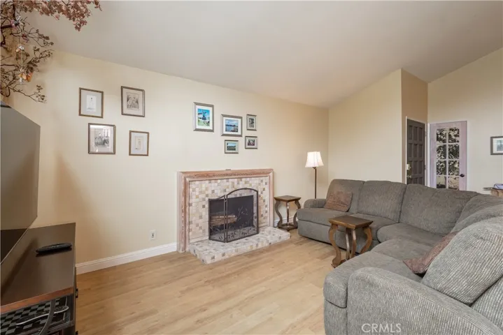 Living room with upgraded tile hearth.  Electric insert used in fireplace.