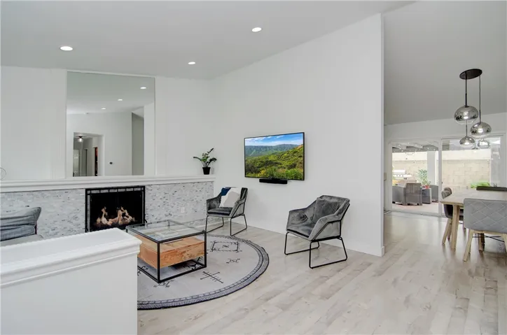 Entry way into open layout with high ceilings and gas fire place