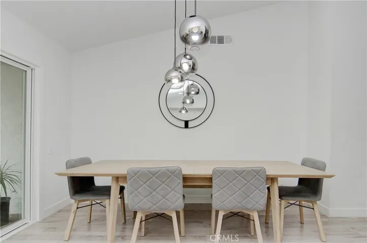 Cafeteria style dining table with ornate modern light fixtures