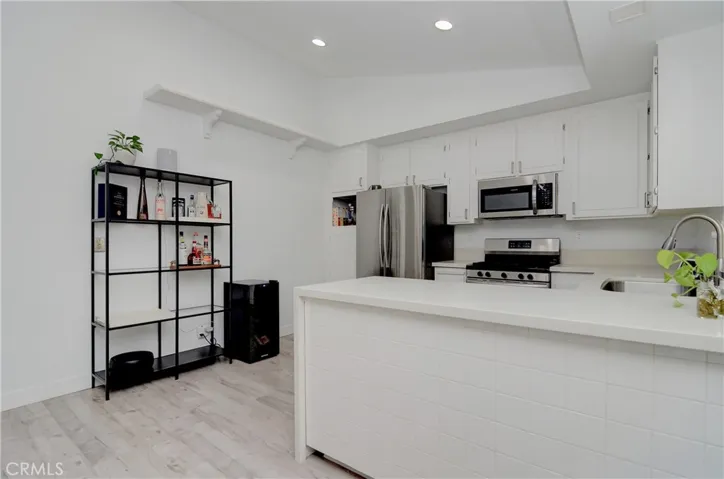 High ceilings with recessed lighting in Kitchen