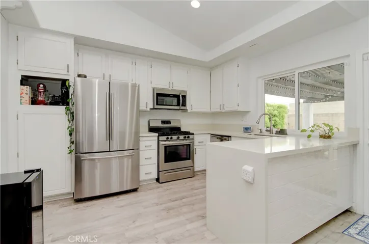 Shaker cabinets with stainless steel appliances. Quartz counter top with waterfall finish.
