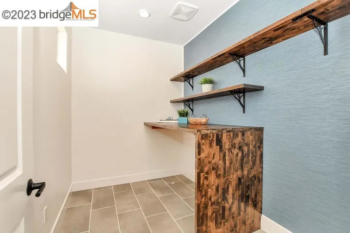 Upstairs laundry with shelves