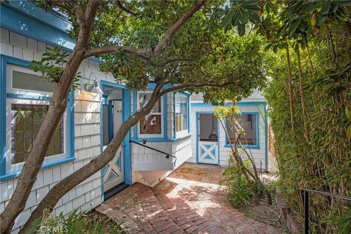 Tree-shaded brick patio greets you at entry.