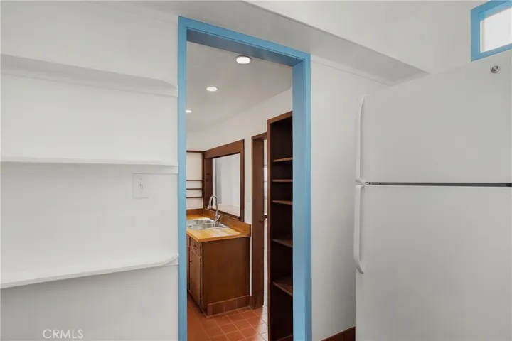Walk-in pantry includes refrigerator.