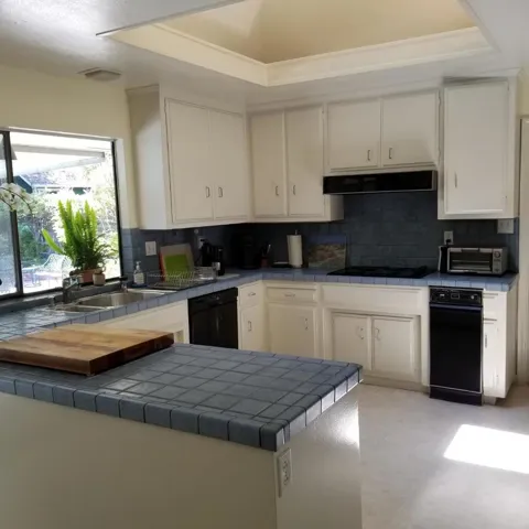 Kitchen overlooking pool and backyard