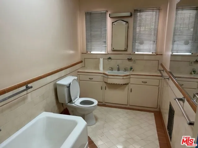Hallway bathroom with tub and stall shower