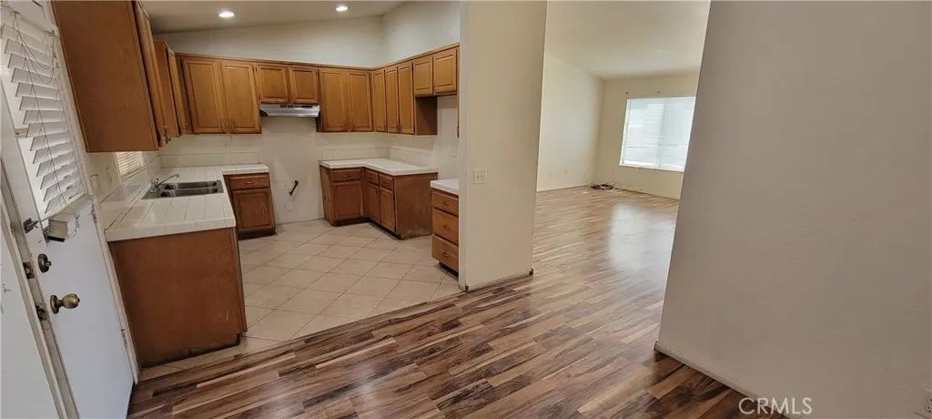 Kitchen with Family Room to the Right and Exit Door to the Backyard on the Left