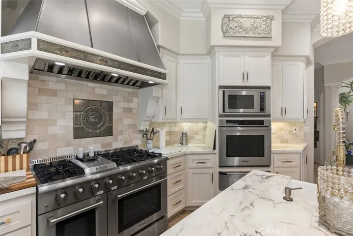 6 burner cook range with griddle, custom hood, three ovens, warming drawer & microwave