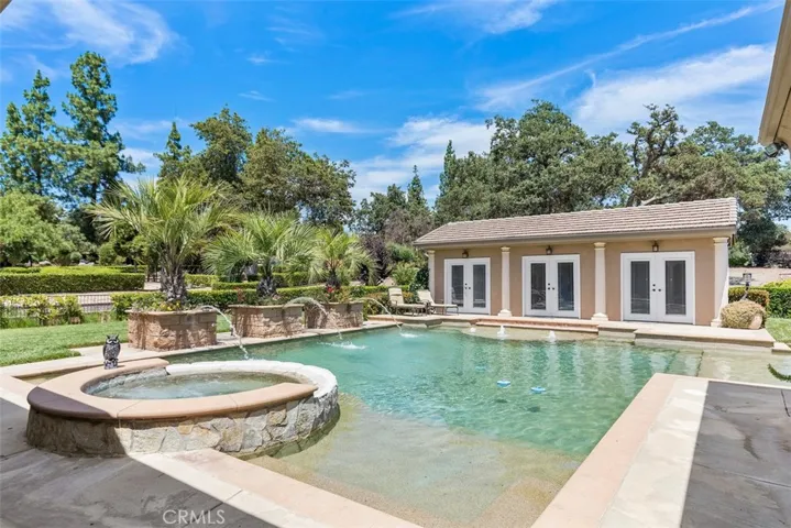 Impressive Pebble Tec pool with spa, baja step and creative water features
