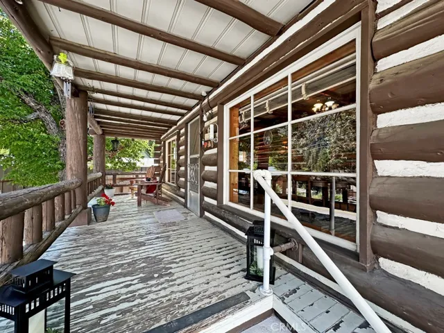 Gorgeous Log Cabin Front Porch. Relax and watch the town's activities on Main Street below.