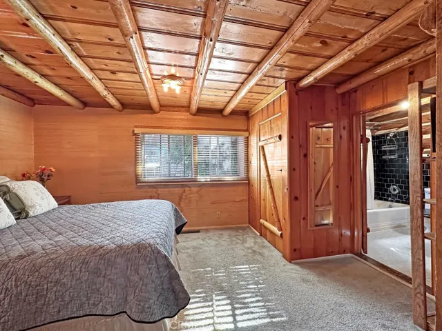 Cozy Log Cabin Primary Bedroom.