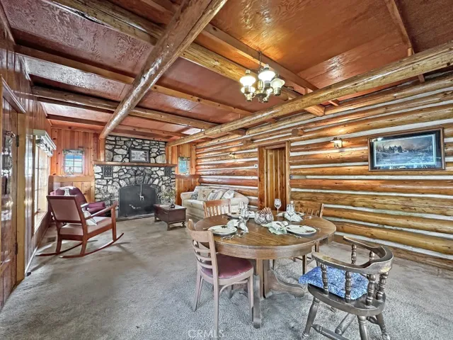 Log Cabin Dining Area and Living Room with spectacular rock fireplace for cooler weather.