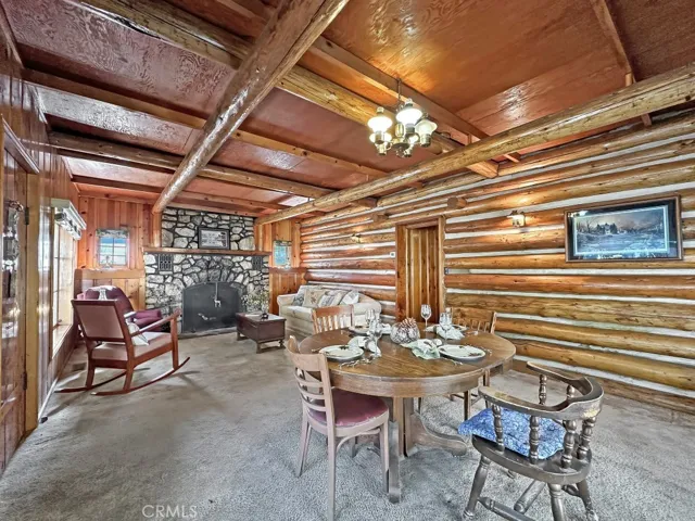 Log Cabin Dining Area and Living Room with spectacular rock fireplace for cooler weather.