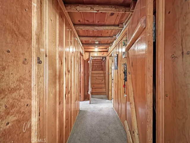 Log Cabin downstairs hallway. Storage galore and doors which can be opened or kept closed for energy savings.