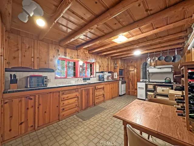 Log Cabin Kitchen with room for everything. Includes a pantry and beautiful vintage range.