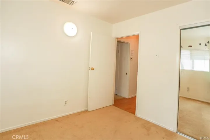 Large Guest Bedroom with Mirror Closet Doors