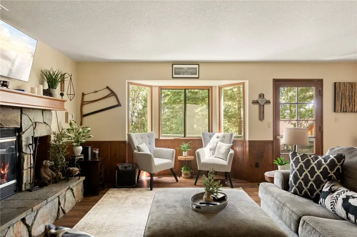 Lovely bay window and single French door look out to the deck.