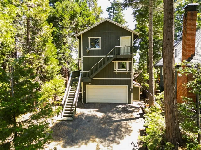 Serene  location and beautiful curb appeal of this 3 level cottage among the trees