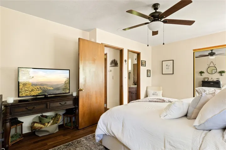 Primary bedroom offers mirrored closet doors, ceiling fan and direct attached bathroom.