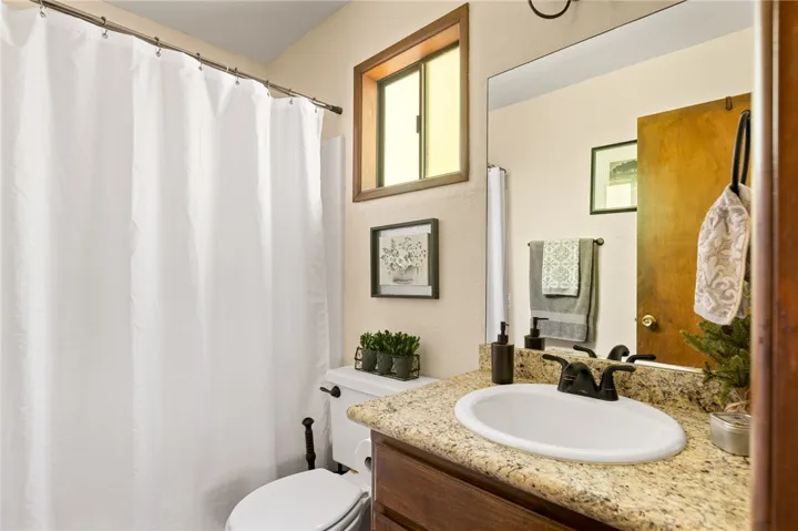 Nice bathroom with shower tub combo, granite counters and quality fixtures.