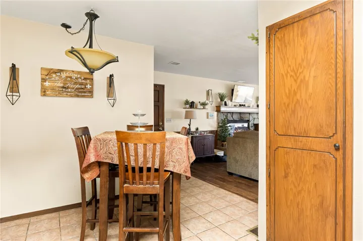 Kitchen dining area offers tile floors with chandelier