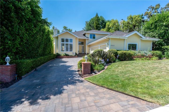 A paver stone lengthy driveway greets you from the street and curves to your 3 car garage