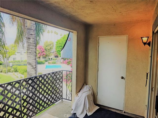 View of balcony; door leads to a small storage area