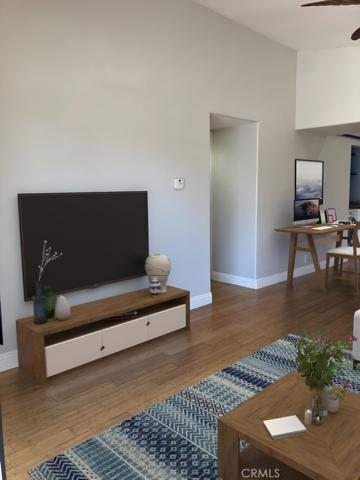 Virtual Staging Photo from Family Room to Dining Room & entry to Kitchen.