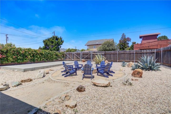 Concrete pad for RV and alleyway access gate in background