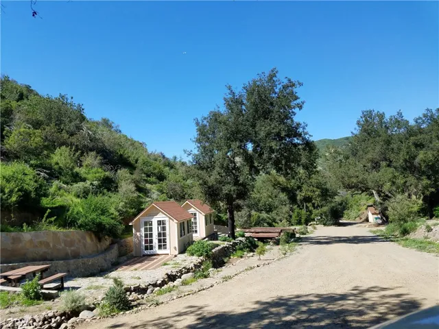 Beige/yellow outbuildings no longer on property. Pictures shown for reference to where the best pads for staging are.