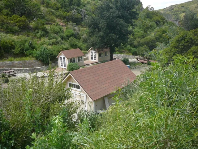Beige/yellow outbuildings no longer on property. Pictures shown for reference to where the best pads for staging are.